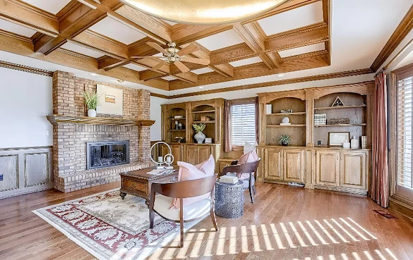 Legato Living Residential Memory Care at Rockbrook senior living community offering assisted living and memory care in Omaha, NE, cozy community sitting area featuring a fireplace and wooden built-in shelves