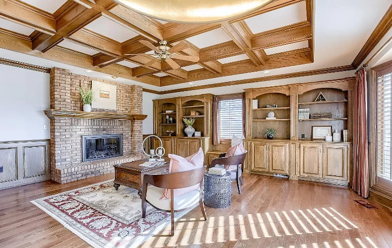 Legato Living Residential Memory Care at Rockbrook senior living community offering assisted living and memory care in Omaha, NE, cozy community sitting area featuring a fireplace and wooden built-in shelves