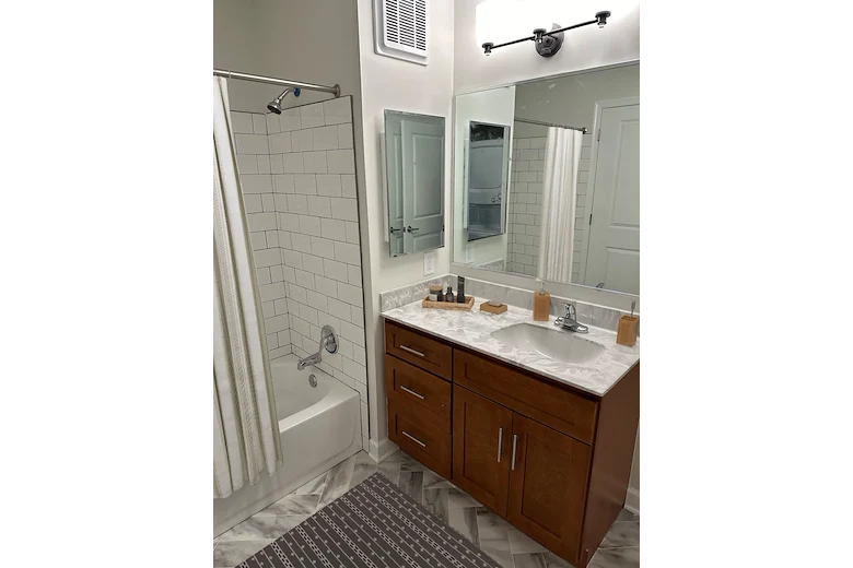 Willow Manor at Cabin Branch senior living community offering independent living and affordable living in Clarksburg, MD, apartment bathroom wiith white tiled shower