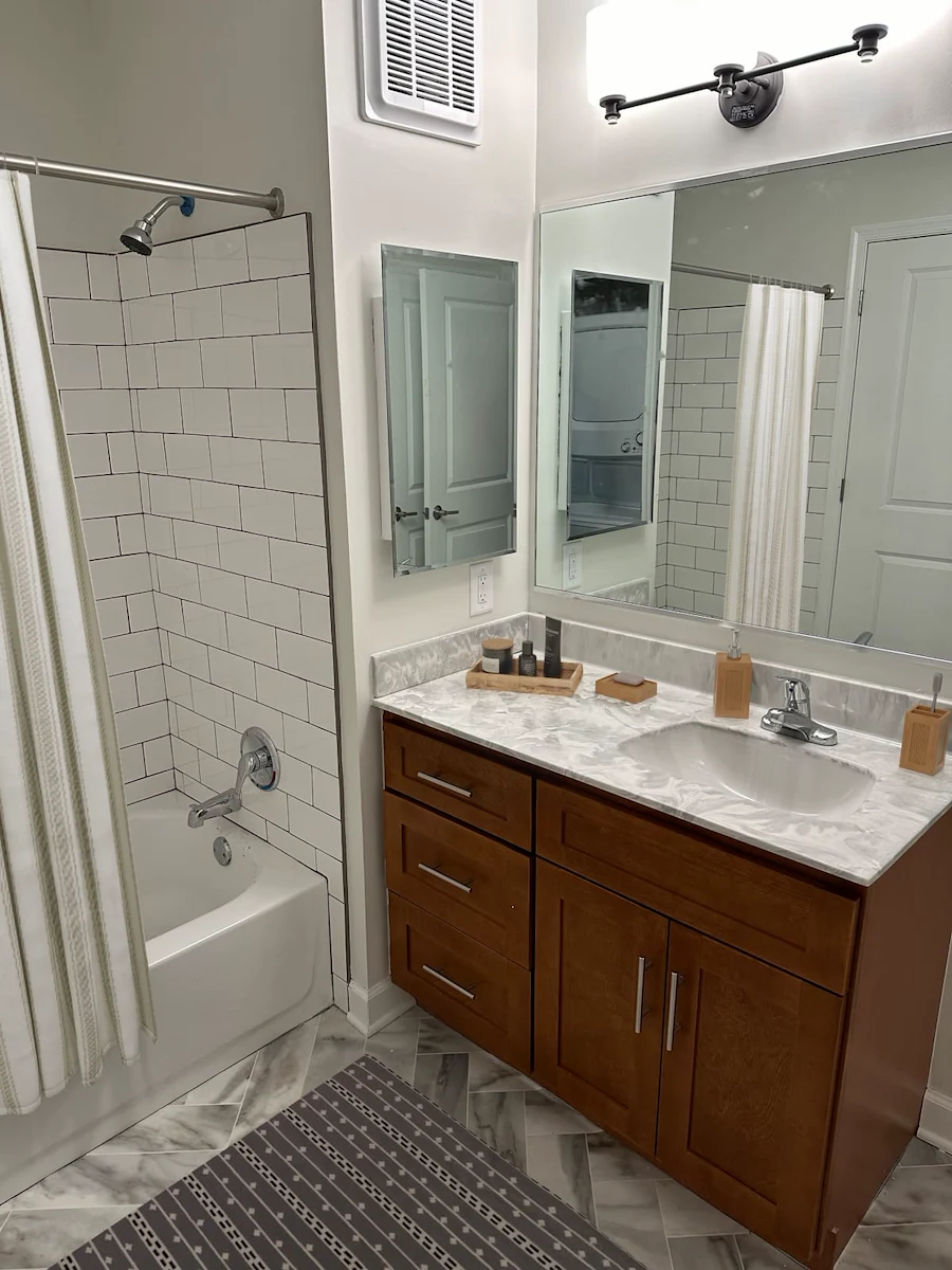 Willow Manor at Cabin Branch senior living community offering independent living and affordable living in Clarksburg, MD, apartment bathroom wiith white tiled shower