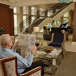 Allegro Richmond Heights senior living offering assisted living, memory care, and respite care in Richmond Heights, MO, resident experience - resident reading a newspaper