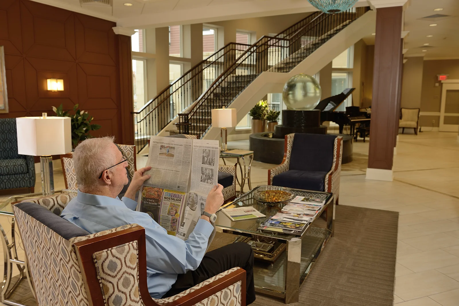 Allegro Richmond Heights senior living offering assisted living, memory care, and respite care in Richmond Heights, MO, resident experience - resident reading a newspaper