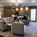 Inviting sitting area at Charter Senior Living of Hopkinsville in Hopkinsville, KY, featuring cozy furniture, warm lighting, and a computer station—designed for comfort and engagement in assisted living and memory care.