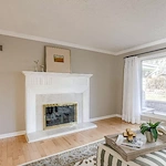 Legato Living Residential Memory Care at Rockbrook senior living community offering assisted living and memory care in Omaha, NE, living room area with a fireplace and great natural lighting