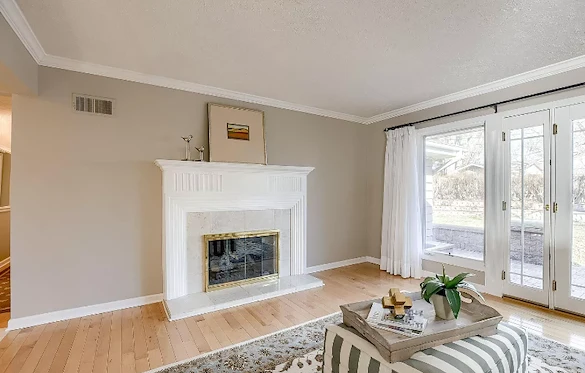 Legato Living Residential Memory Care at Rockbrook senior living community offering assisted living and memory care in Omaha, NE, living room area with a fireplace and great natural lighting