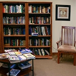 Enjoy our fully stocked library with space for private reading.