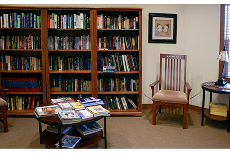Enjoy our fully stocked library with space for private reading.