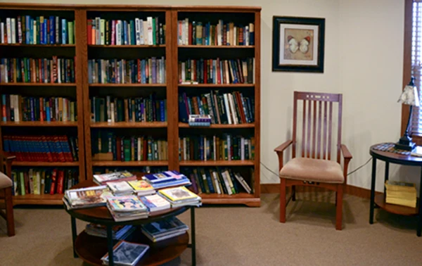 Enjoy our fully stocked library with space for private reading.