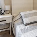 Legato Living Residential Memory Care at Five Fountains senior living community offering assisted living, memory care, adult day services, and respite care in Elkhorn, NE, bed and nightstand