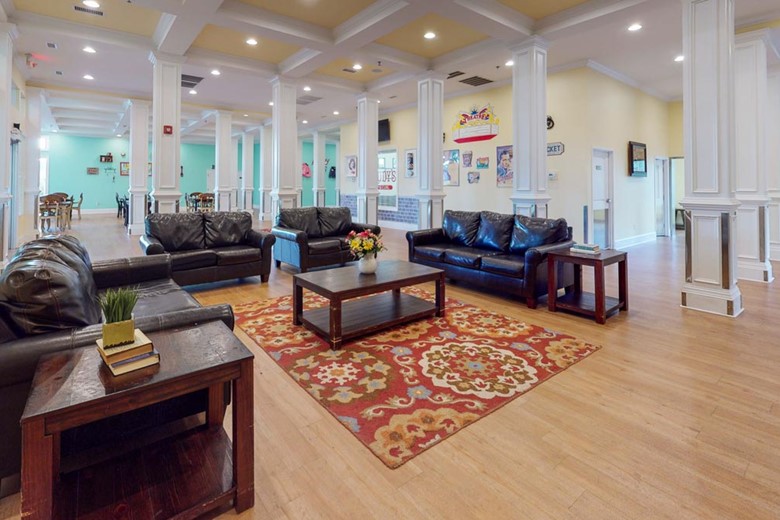 Open concept lounge area with lots of natural light at Orchard Ridge Residencies