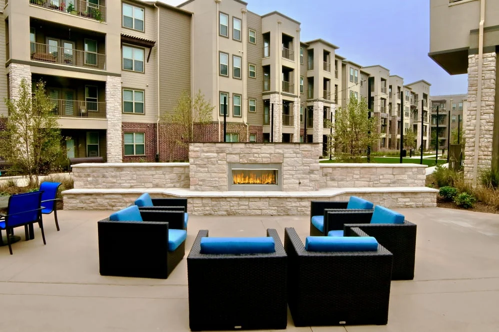 Active adult living and independent living at Watercrest at Shadow Creek Ranch in Pearland, TX, comfortable outdoor sitting area by a fireplace