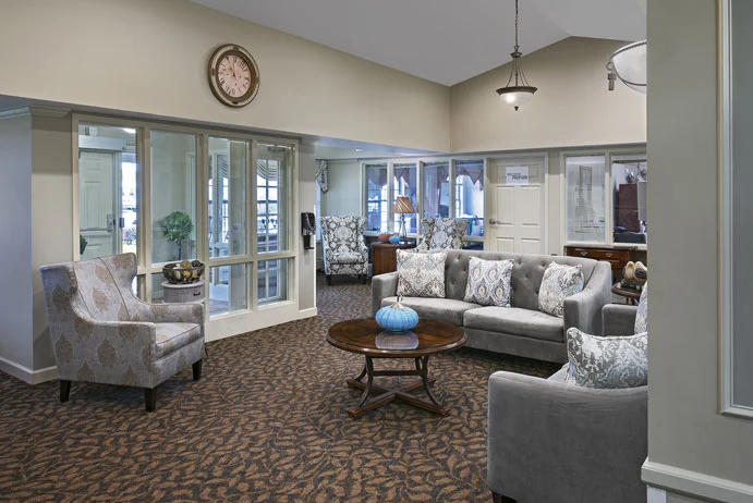 American House Stone senior living community offering independent living and respite care in Rochester Hills, MI, front entrance and community living room seating area