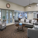 American House Stone senior living community offering independent living and respite care in Rochester Hills, MI, front entrance and community living room seating area