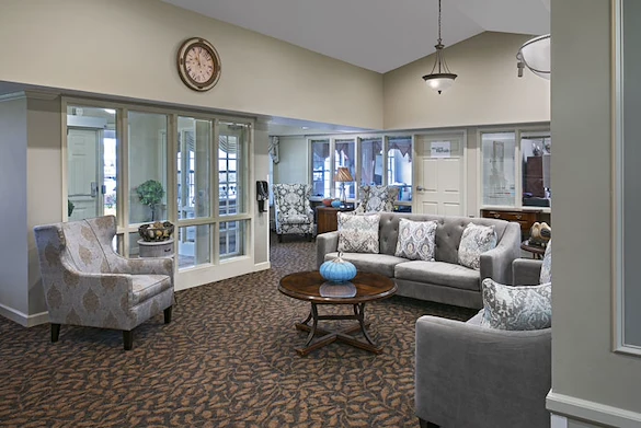 American House Stone senior living community offering independent living and respite care in Rochester Hills, MI, front entrance and community living room seating area