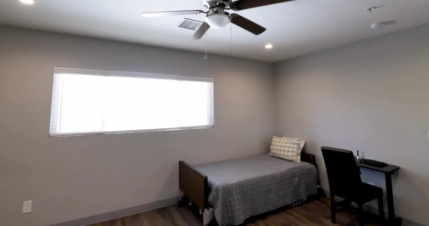 Legato Living Residential Memory Care at Old Town senior living community offering assisted living and memory care in Scottsdale, AZ, bedroom with a bed and a desk