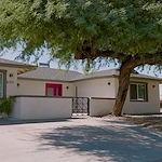 Legato Living Residential Memory Care at Old Town senior living community offering assisted living and memory care in Scottsdale, AZ, front exterior featuring a bright red front door