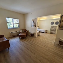 Lenox on the Lake senior living community offering assisted living and memory care in Lauderhill, FL, apartment living area and bedroom 