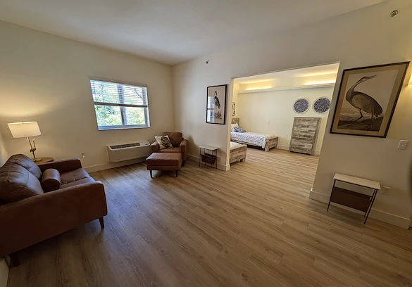 Lenox on the Lake senior living community offering assisted living and memory care in Lauderhill, FL, apartment living area and bedroom 
