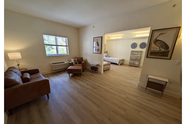 Lenox on the Lake senior living community offering assisted living and memory care in Lauderhill, FL, apartment living area and bedroom 