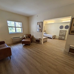 Lenox on the Lake senior living community offering assisted living and memory care in Lauderhill, FL, apartment living area and bedroom 