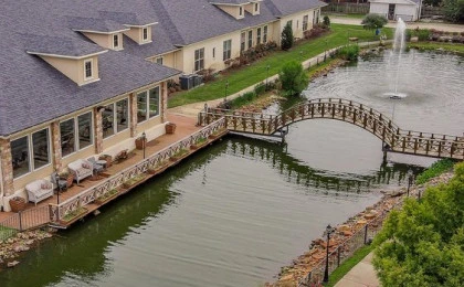 Montclair Park Assisted and Independent Senior Living in Shreveport, LA bridge over water with fountain
