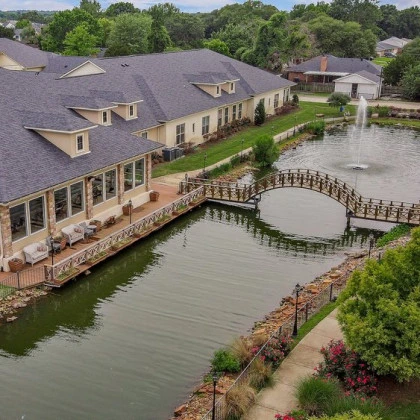 Montclair Park Assisted and Independent Senior Living in Shreveport, LA bridge over water with fountain