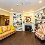 Westlake Woods by New Perspective senior living community offering assisted living in Erie, PA, lounge area by fireplace