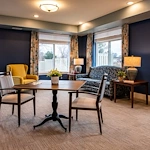 Independent living, assisted living, memory care, and respite care at Broadwell Senior Living – Plymouth in Plymouth, MN, community room with a lounging area and tables for games