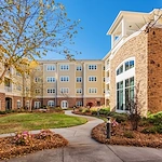 Brightmore of South Charlotte senior living community offering independent living, assisted living, and memory care in Charlotte, NC, outdoor space with a walking path