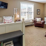 Bed and living area in one of Orchard Ridge's housing spaces