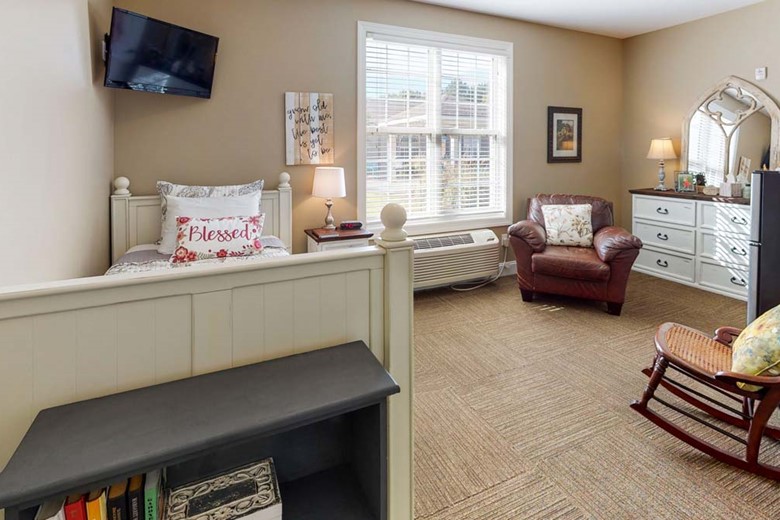 Bed and living area in one of Orchard Ridge's housing spaces
