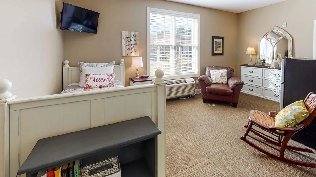 Bed and living area in one of Orchard Ridge's housing spaces