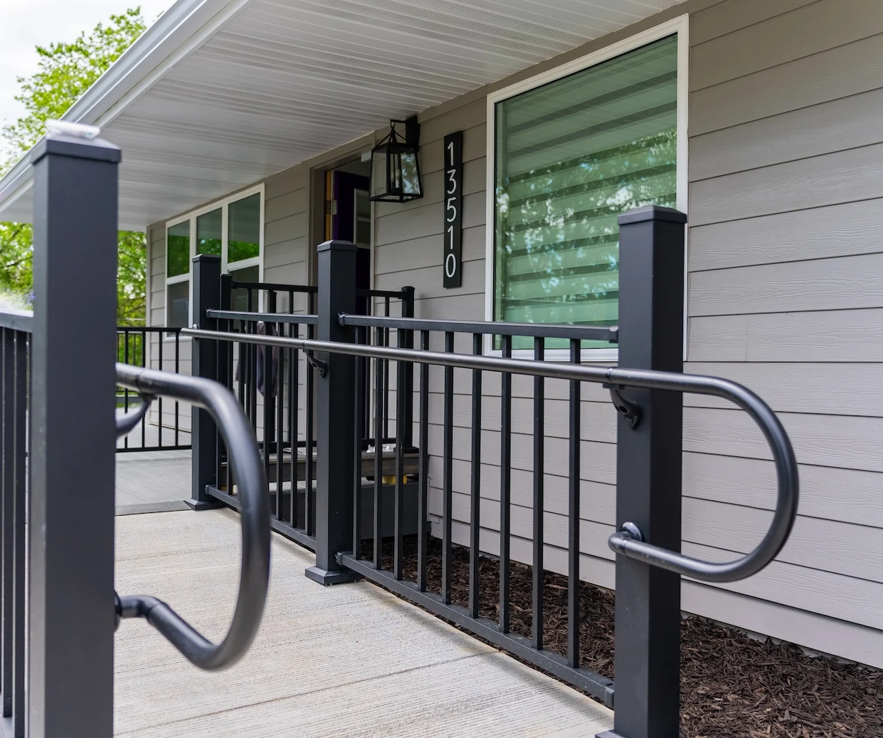 Legato Living Residential Memory Care at Heartland Hills senior living community offering assisted living, memory care, adult day services, and respite care in Bellevue, NE, entrance with a sidewalk and handrails leading to the front door