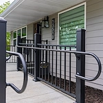 Legato Living Residential Memory Care at Heartland Hills senior living community offering assisted living, memory care, adult day services, and respite care in Bellevue, NE, entrance with a sidewalk and handrails leading to the front door