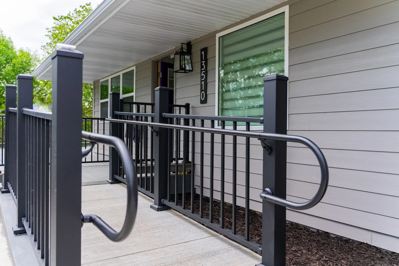 Legato Living Residential Memory Care at Heartland Hills senior living community offering assisted living, memory care, adult day services, and respite care in Bellevue, NE, entrance with a sidewalk and handrails leading to the front door