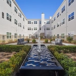 Alto Johns Creek, senior living community offering assisted living, memory care, and respite care in Duluth, GA, outdoor area with seating and a water feature