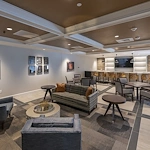 Alto Evergreen Walk, senior living community offering assisted living, memory care, and respite care in South Windsor, CT, lounge area with comfortable seating, tables and chairs, and bar-top seating 