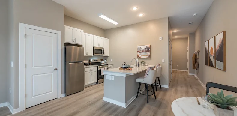 Acclaim at Cary Pointe, senior living community offering active adult and independent living in Cary, NC, apartment kitchen with stainless-steel appliances