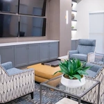 Watermere at the Preserve senior living community offering active adult living and independent living in North Richland Hills, TX, community sitting area with four TVs mounted on the wall for a variety of viewing options