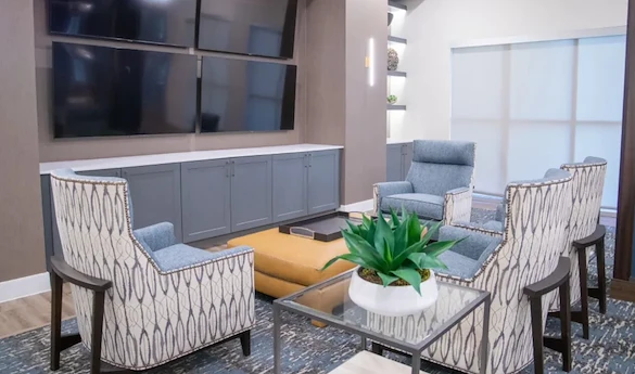 Watermere at the Preserve senior living community offering active adult living and independent living in North Richland Hills, TX, community sitting area with four TVs mounted on the wall for a variety of viewing options