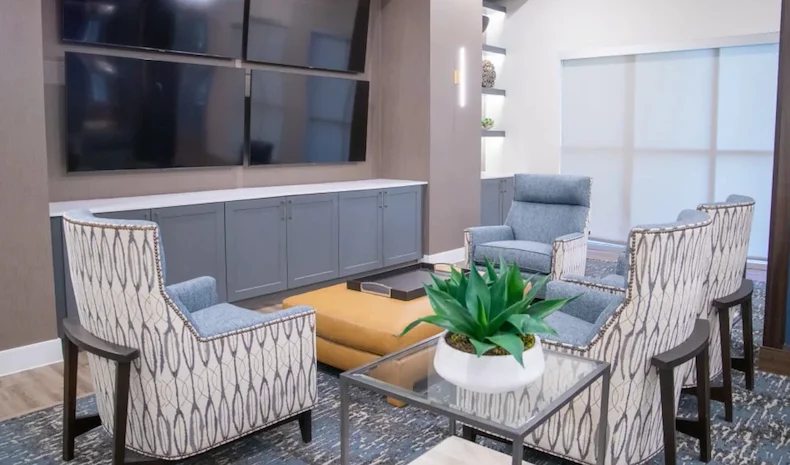 Watermere at the Preserve senior living community offering active adult living and independent living in North Richland Hills, TX, community sitting area with four TVs mounted on the wall for a variety of viewing options