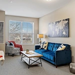 Alto Wheaton, senior living community offering assisted living, memory care, and respite care in Wheaton, IL, apartment living room with great natural lighting