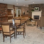 Zionsville Meadows Assisted Living, senior living community offering independent living and assisted living in Zionsville, IN, community room with cozy seating by fireplace