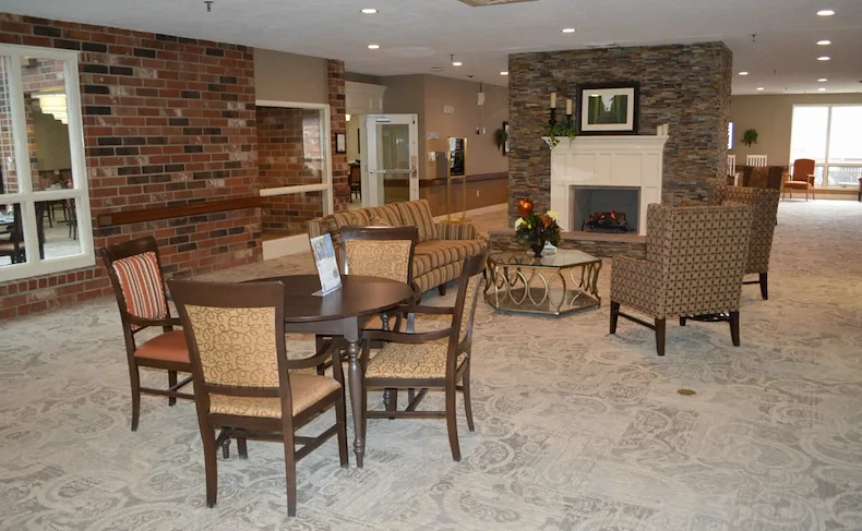 Zionsville Meadows Assisted Living, senior living community offering independent living and assisted living in Zionsville, IN, community room with cozy seating by fireplace