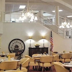 Ashley Park by Barclay House independent senior living in Charleston, SC, dining room with grand staircase in the background