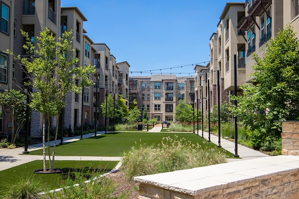 Active adult living and independent living at Watercrest at Shadow Creek Ranch in Pearland, TX, outdoor green space with a walking path