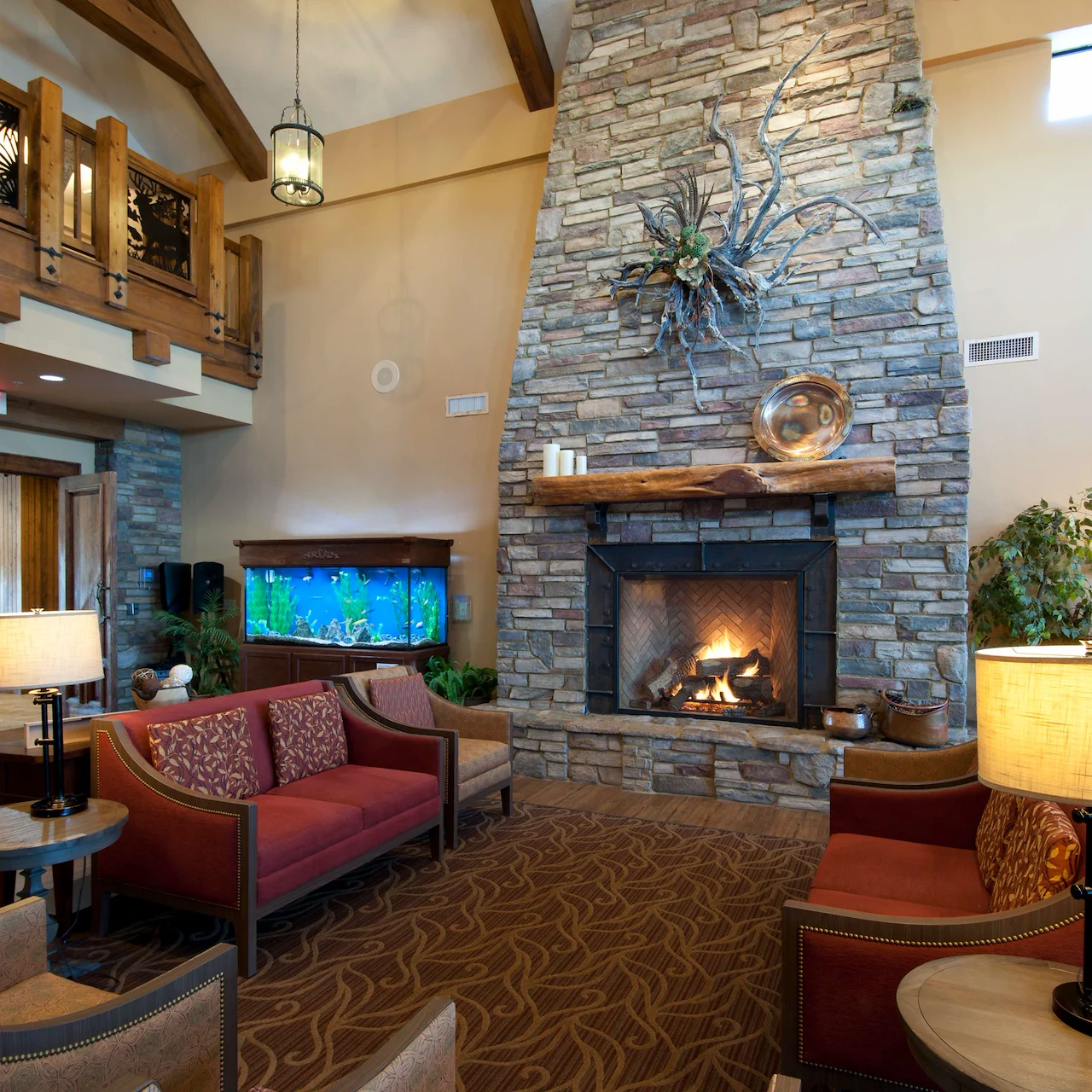 Alto Tavares, senior living community offering assisted living, memory care, and respite care in Tavares, FL, comfortable sitting area by a fireplace