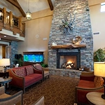 Alto Tavares, senior living community offering assisted living, memory care, and respite care in Tavares, FL, comfortable sitting area by a fireplace