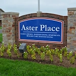 Aster Place senior living community offering independent living, assisted living, memory care, and respite care in Lafayette, IN, front entrance sign that reads "Aster Place Garden Homes, Assisted Living Apartments, Memory Care Assisted Living"