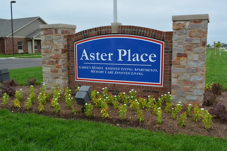 Aster Place senior living community offering independent living, assisted living, memory care, and respite care in Lafayette, IN, front entrance sign that reads "Aster Place Garden Homes, Assisted Living Apartments, Memory Care Assisted Living"